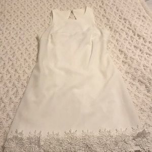 Women’s white dress with flowers at the bottom